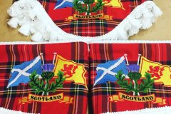 Pelmet and pair of tiebacks in Stewart Royal tartan with white tassel trim, featuring the Saltire and Lions Rampant flags.
